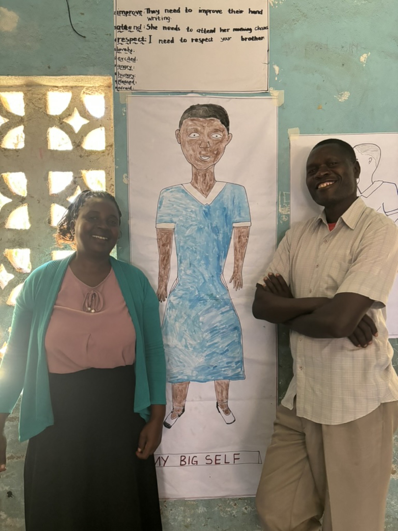 Teachers beside a child's “My Big Self” drawing